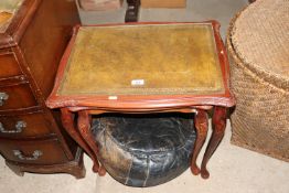 A nest of two leather topped occasional tables and