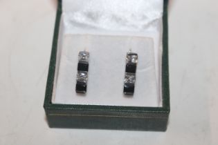 A pair of silver ear-rings set with sapphire colou