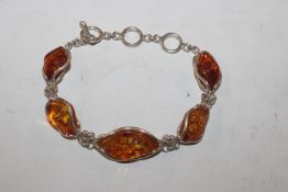 A large Sterling silver and amber bracelet, approx