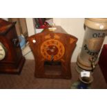 An Art Nouveau oak and inlaid wall clock of swept