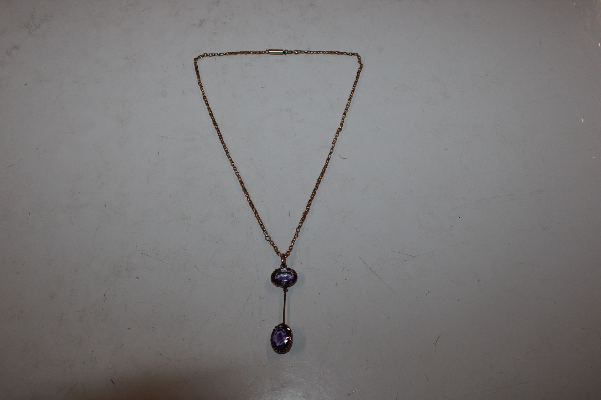 A 9ct gold necklace with amethyst pendant, approx.