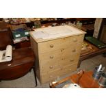 An antique stripped pine chest fitted four long dr