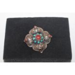 An antique silver turquoise and coral brooch