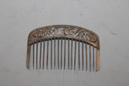 A Chinese white metal hair comb with dragon orname