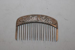 A Chinese white metal hair comb with dragon orname