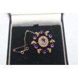 A yellow metal amethyst and seed pearl set brooch,