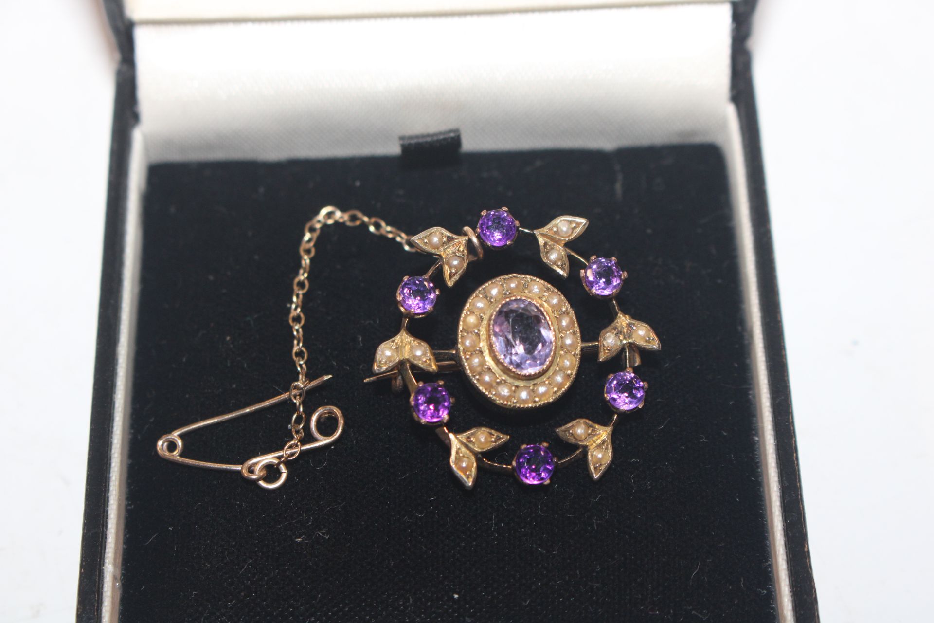 A yellow metal amethyst and seed pearl set brooch,