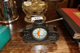 A bronzed clock in the form of a tank