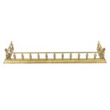 An ornate brass fender, approx. 135cm long