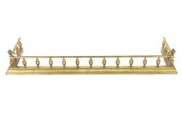 An ornate brass fender, approx. 135cm long