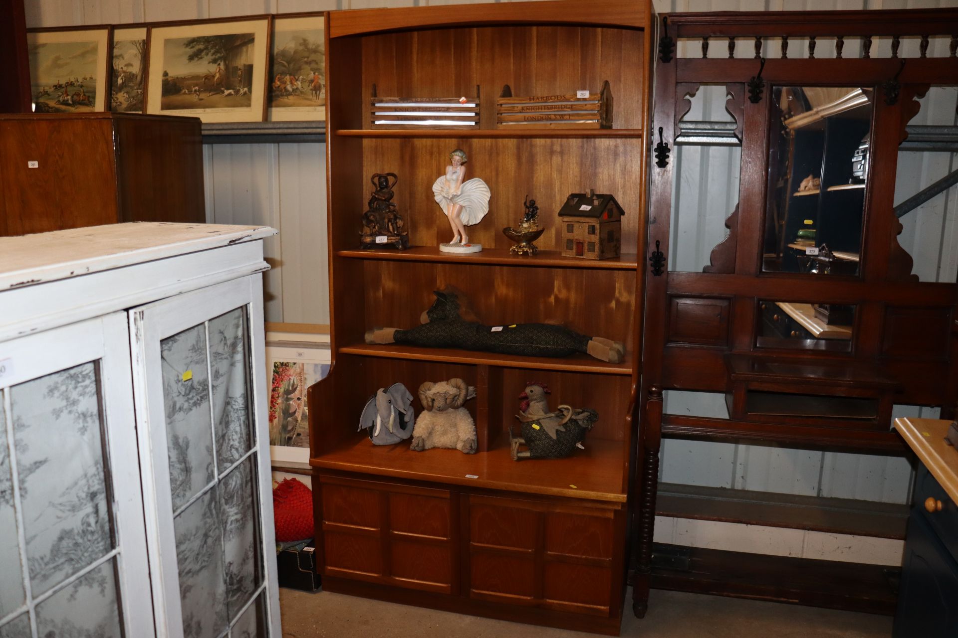 A Nathan bookcase raised on cupboard base