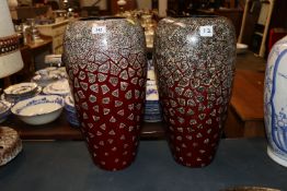 A pair of decorative red glazed vases