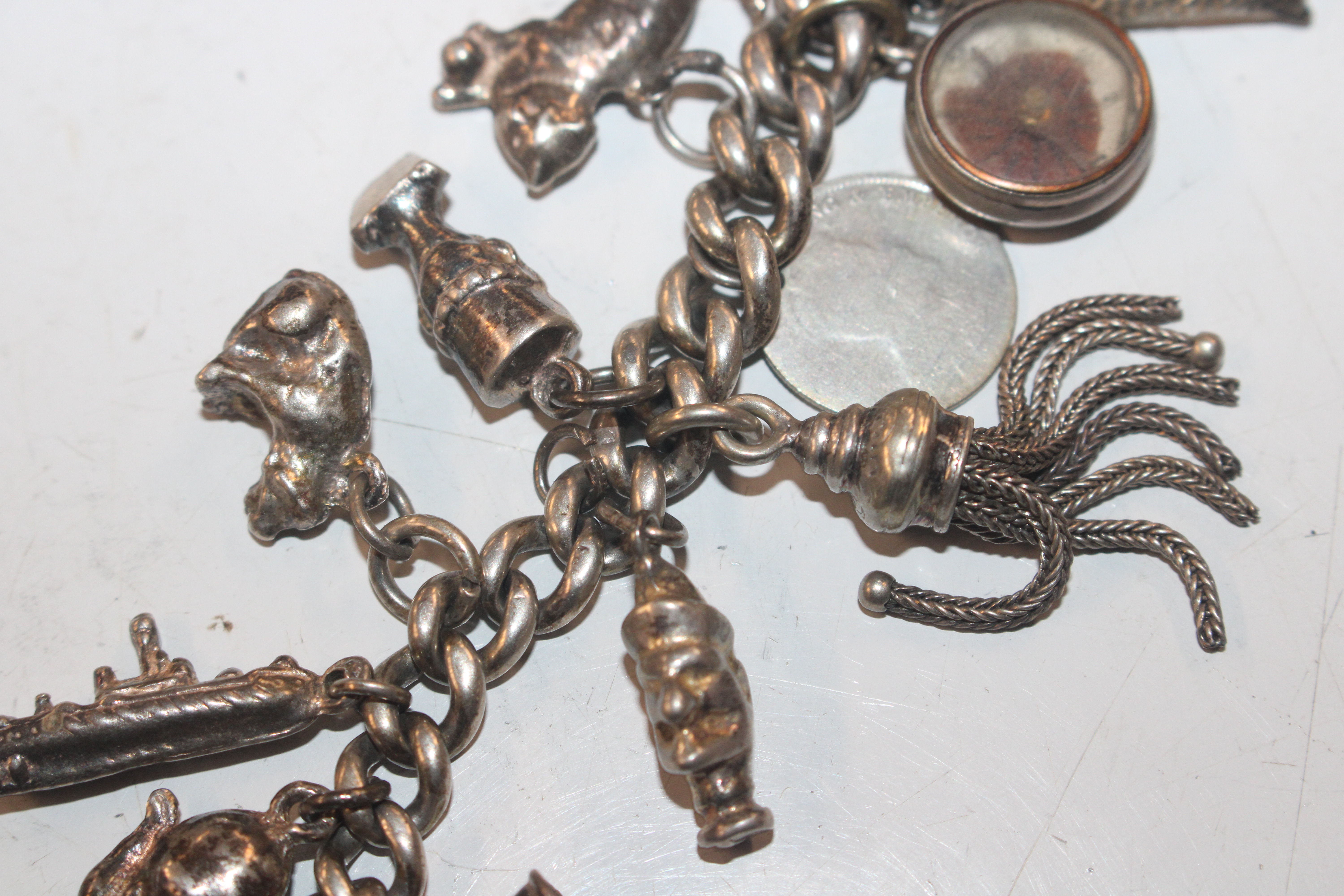 A silver charm bracelet with various silver and wh - Image 3 of 11