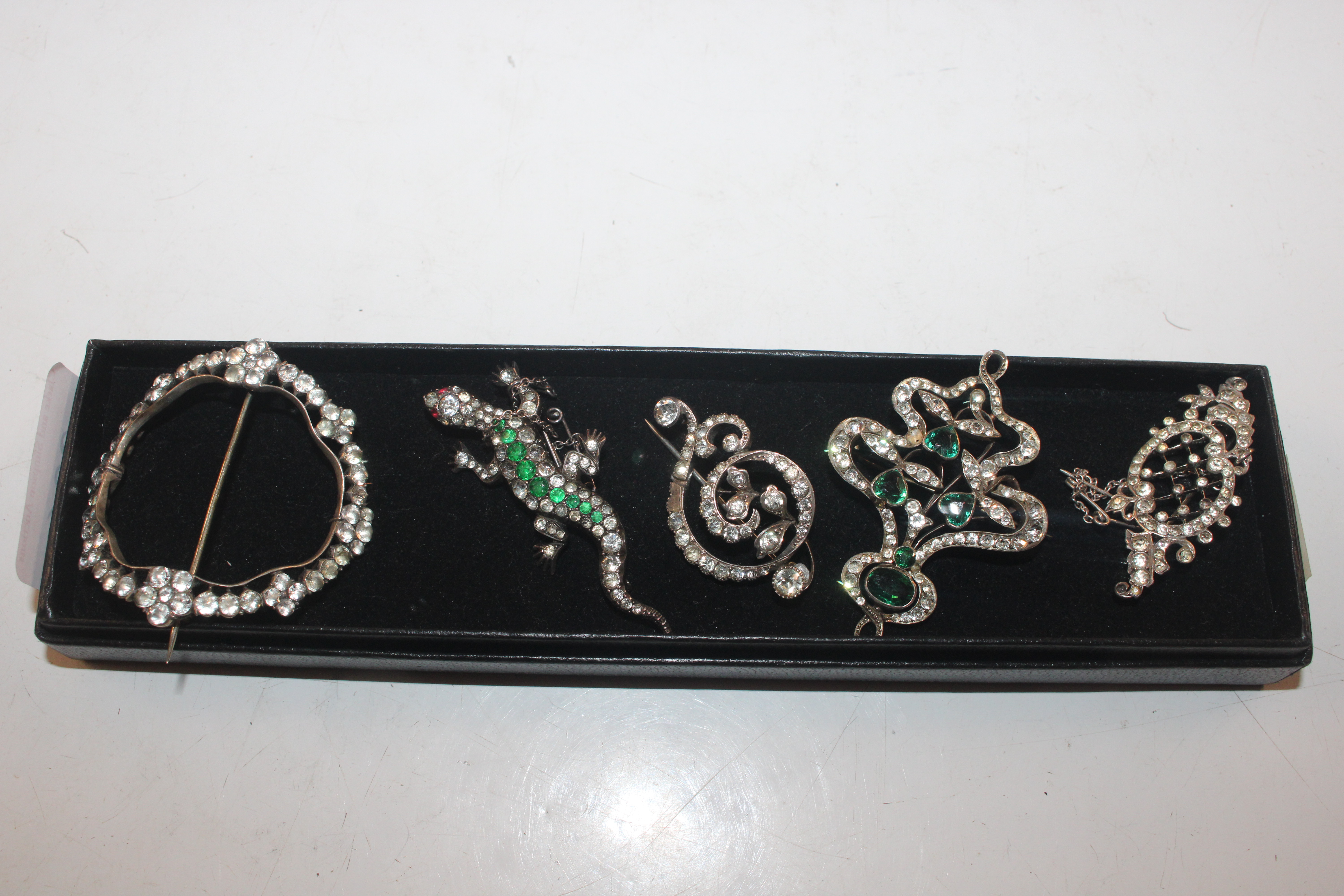 Five brooches set with white and coloured stones