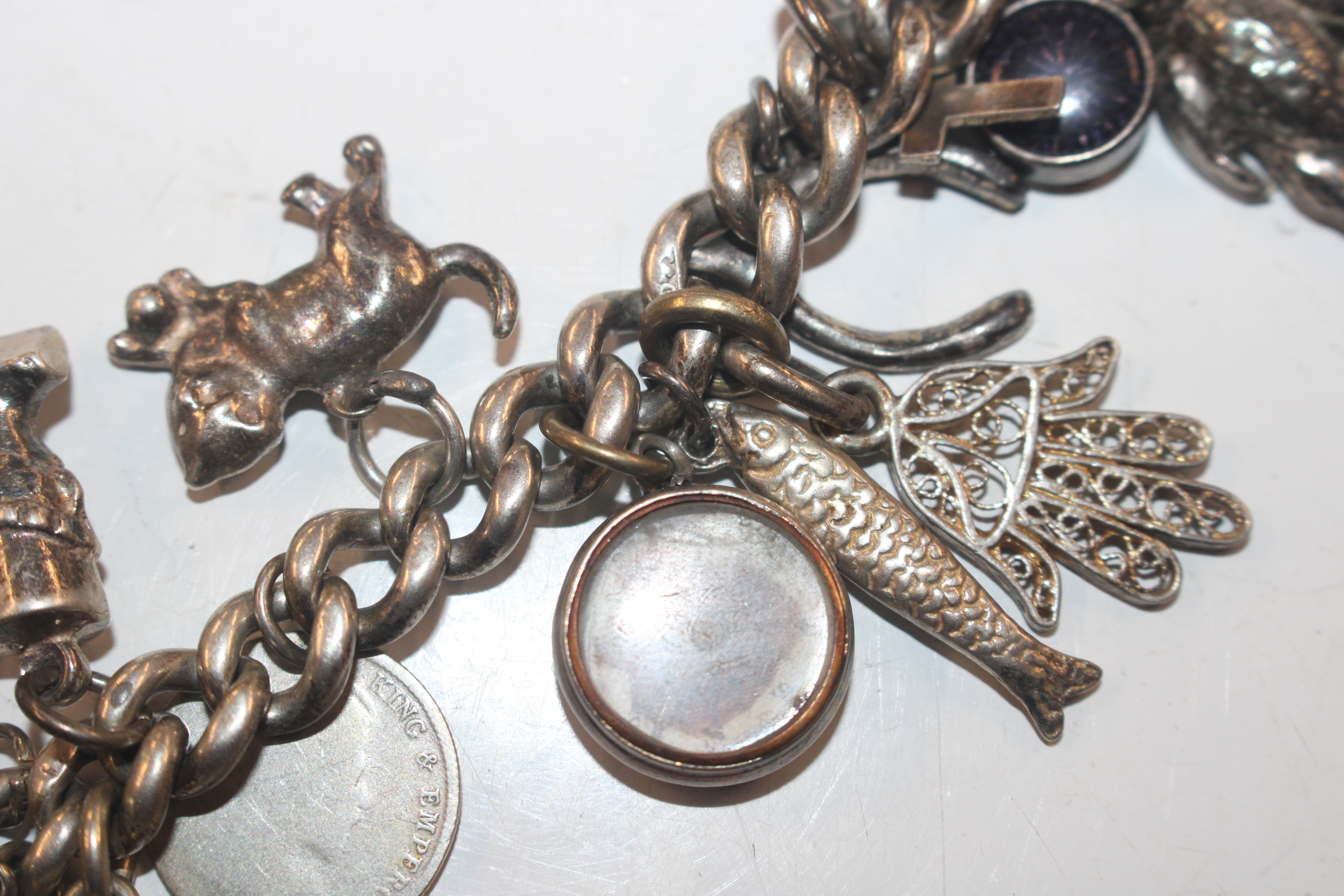 A silver charm bracelet with various silver and wh - Image 4 of 11