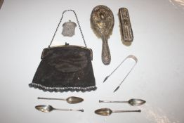 A pair of silver sugar tongs and a set of four sil