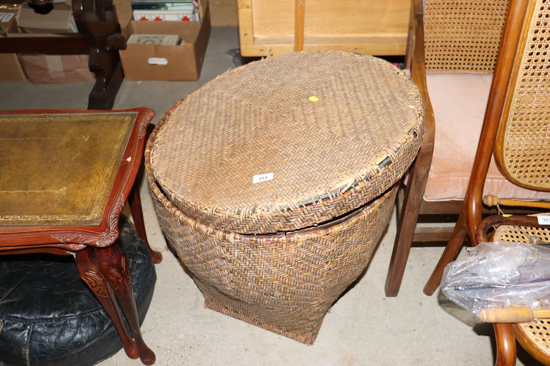 A wicker covered basket and lid