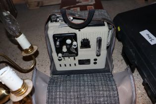 A small case, a Eumig P8 Phonomatic projector and