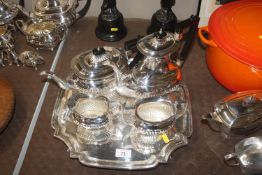 A plated four piece tea set with half fluted body