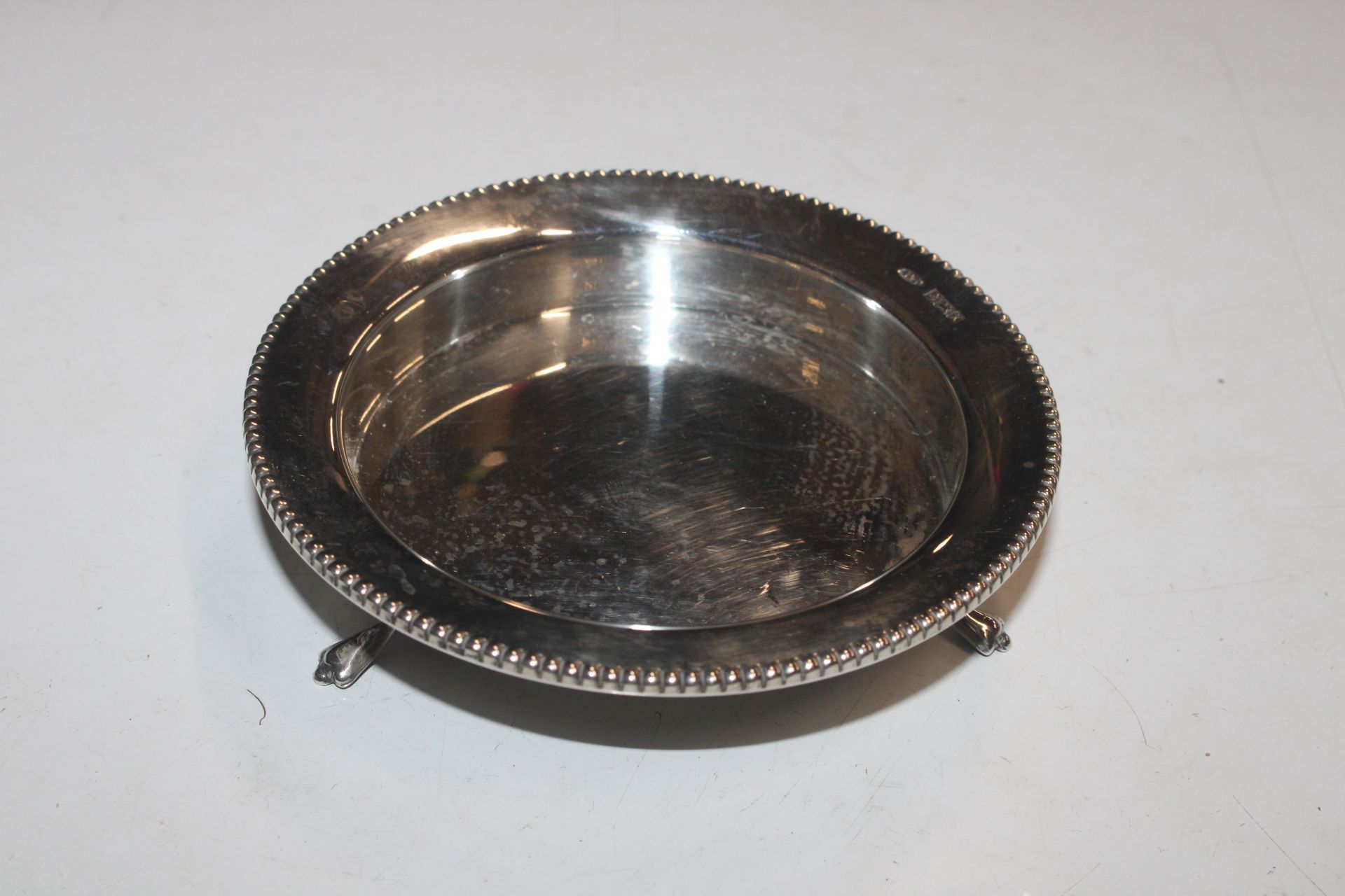 A circular silver dish raised on three supports, a - Image 2 of 6