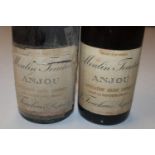 A bottle of Moulin Touchais 1929; and another 1959