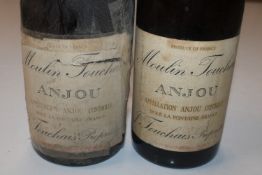 A bottle of Moulin Touchais 1929; and another 1959