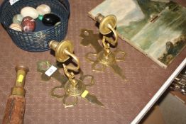 A pair of brass wall candle holders