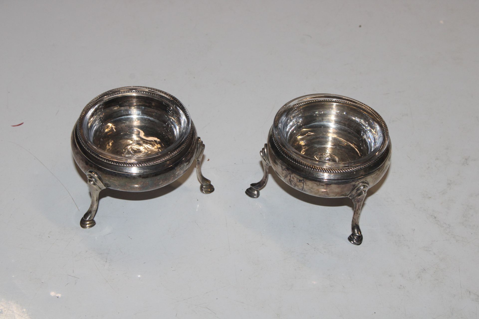 A pair of silver salts with glass liners, approx t