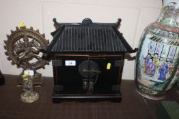 An Oriental lacquered pagoda shaped table top trin