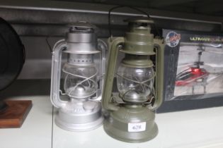 Two medium sized hurricane lamps