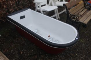 A roll top bath with ornate chrome feet (disassemb