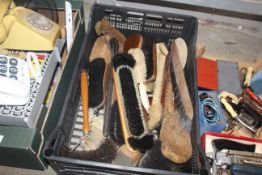 A crate of various vintage cleaning brushes