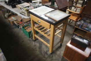 An oak and black granite kitchen trolley fitted si