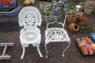Two ornate painted aluminium chairs