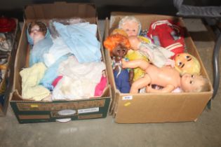 Two boxes of various vintage dolls and clothes
