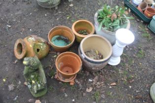 A quantity of various sized garden planters, garden ornament of a lady sitting on a bench etc.