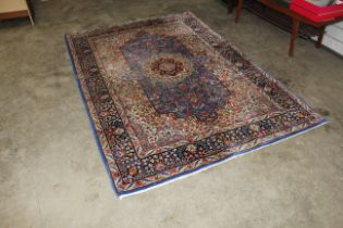 An approx. 8'1" x 5'6" blue patterned rug AF