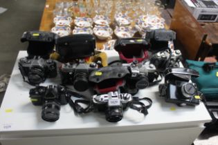 A quantity of cameras to include Canon, Yashica, Practika etc