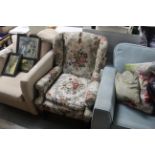 A floral upholstered wing back chair on cabriole s