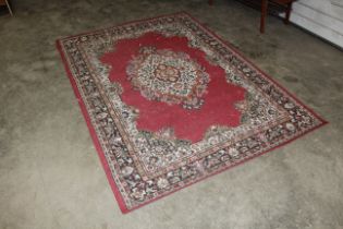 An approx. 7'7" x 5'4" red patterned rug AF