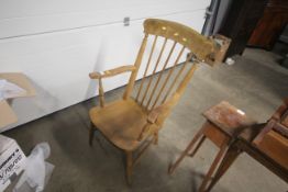 A Victorian elm seated stick back elbow chair