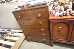 A mid 20th Century oak chest of five drawers