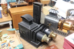 A 20th Century mental and brass mounted magic lantern, an early 20th Century spirit fired brass