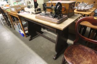 An oak refectory type table on shaped end supports