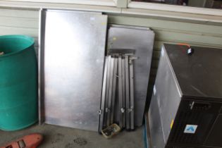 Two stainless steel tables (dis-assembled) with two stainless steel worktops - this lot is subject