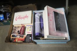 A box of various stationery, calligraphy books, a