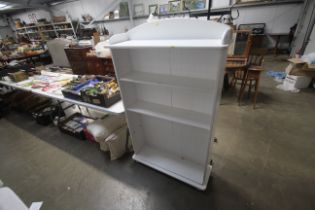 A white painted four tier bookcase