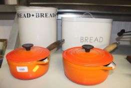 Two Le Creuset saucepans, a metal bread bin and a