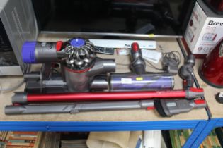 A Dyson V8 total clean vacuum with attachments