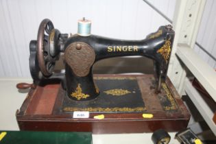 A Singer hand sewing machine lacking case